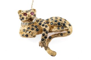 9CT GOLD LEOPARD BROOCH, set with sapphires, diamond chips and ruby eyes, 11.4gms Provenance: