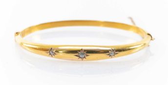15CT GOLD DIAMOND HINGED BANGLE, three 'gypsy' set stones, 6.9gms Provenance: private collection