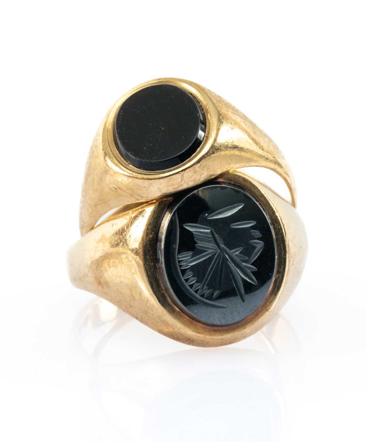 TWO GOLD RINGS comprising 9ct gold believed hematite intaglio ring, together with a 9ct gold onyx