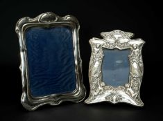 TWO EDWARD VII ART NOUVEAU SILVER PHOTOGRAPH FRAMES, smaller repousse decorated with putti and