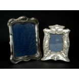 TWO EDWARD VII ART NOUVEAU SILVER PHOTOGRAPH FRAMES, smaller repousse decorated with putti and