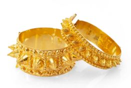 TWO SIMILAR YELLOW METAL MIDDLE EASTERN BANGLES, of pointed conical design, with maker's initials,