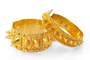 TWO SIMILAR YELLOW METAL MIDDLE EASTERN BANGLES, of pointed conical design, with maker's initials,