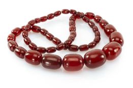 GRADUATED SINGLE STRAND OF CHERRY AMBER COLOURED BEADS, 13mms - 25mms wide, 112.4gms Provenance: