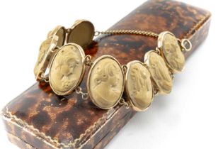 19TH C. ITALIAN 9CT GOLD FRAMED LAVA PANEL BRACELET, composed of 8 oval cameos of classical female