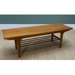 MID-CENTURY TEAK COFFEE TABLE, slightly tapered at each end in 'surfboard' form, with magazine