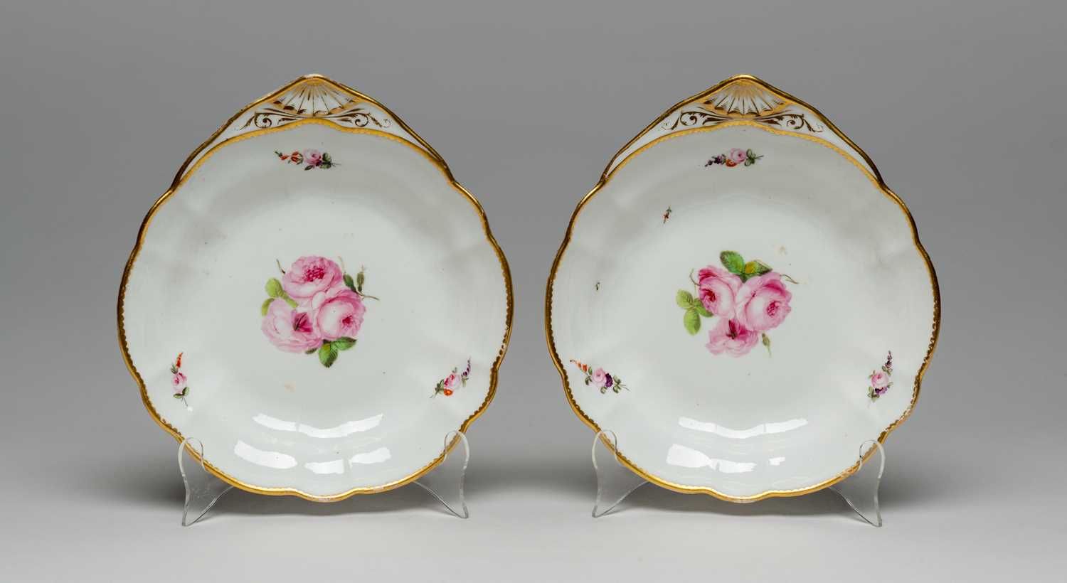 PAIR OF NANTGARW PORCELAIN FAN-HANDLED DESSERT DISHES circa 1813-1820, centres painted with sprays