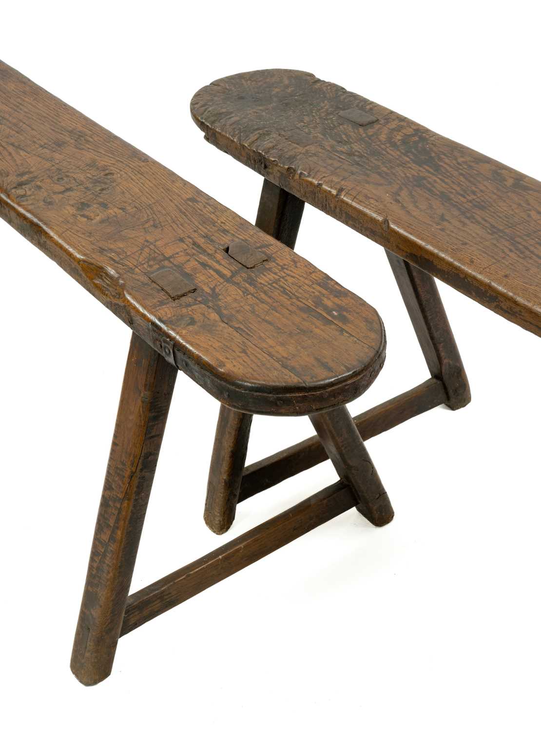 PAIR PRIMITIVE JOINED OAK LONG BENCHES, 19th Century, on A-shaped trestle end supports mortised