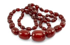 CHERRY RED AMBER BAKELITE GRADUATED BEAD NECKLACE, beads from 30mm to 13mm (w), appr. 102cm (