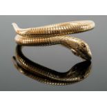 9CT GOLD COILED SNAKE BANGLE, the snake head terminal set with two ruby eyes, 26.3gms Provenance: