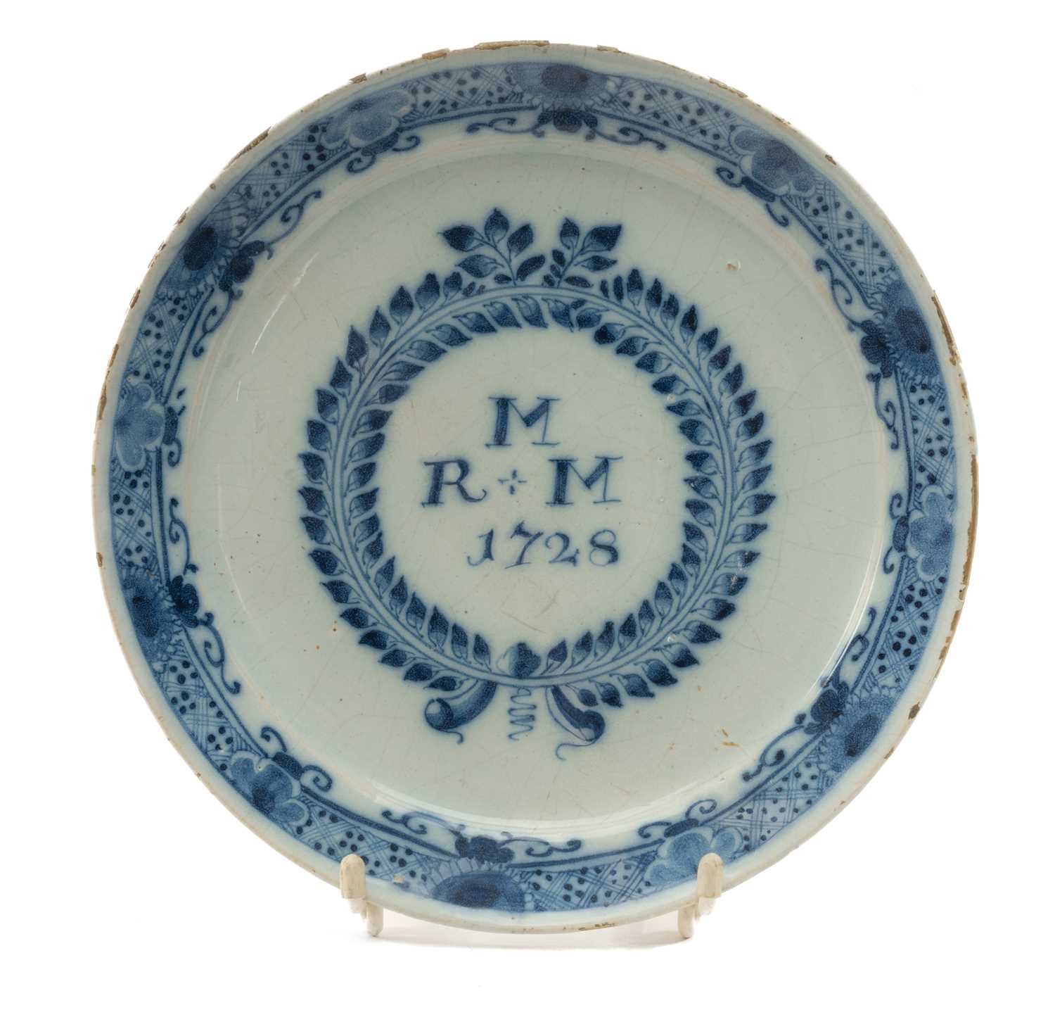 GEORGE II ENGLISH DELFT MARRIAGE PLATE, dated 1728, centre painted with initials 'R+M M' within