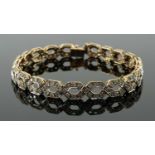 9CT GOLD DIAMOND ENCRUSTED BRACELET, repeating helix design, 19cms long, 14.5gms in box