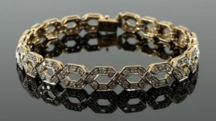 9CT GOLD DIAMOND ENCRUSTED BRACELET, repeating helix design, 19cms long, 14.5gms in box