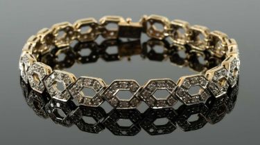 9CT GOLD DIAMOND ENCRUSTED BRACELET, repeating helix design, 19cms long, 14.5gms in box