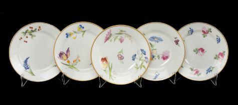 FIVE SIMILAR SWANSEA PORCELAIN PLATES non-moulded with floral decoration within solid gilt rims,