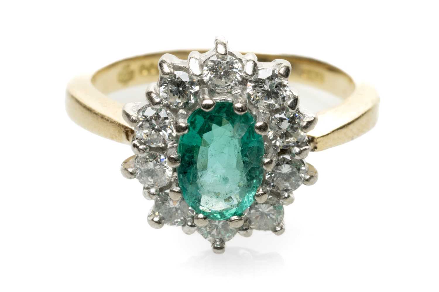 18CT GOLD EMERALD & DIAMOND CLUSTER RING, the central oval emerald (7 x 4mms approx.) within