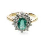 18CT GOLD EMERALD & DIAMOND CLUSTER RING, the central oval emerald (7 x 4mms approx.) within