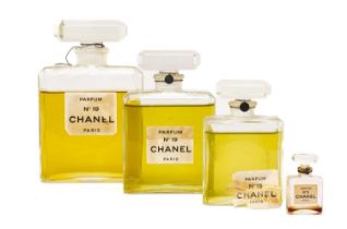 VINTAGE PERFUME comprising three graduated glass bottles of 'Chanel No 19 Parfum Paris' with