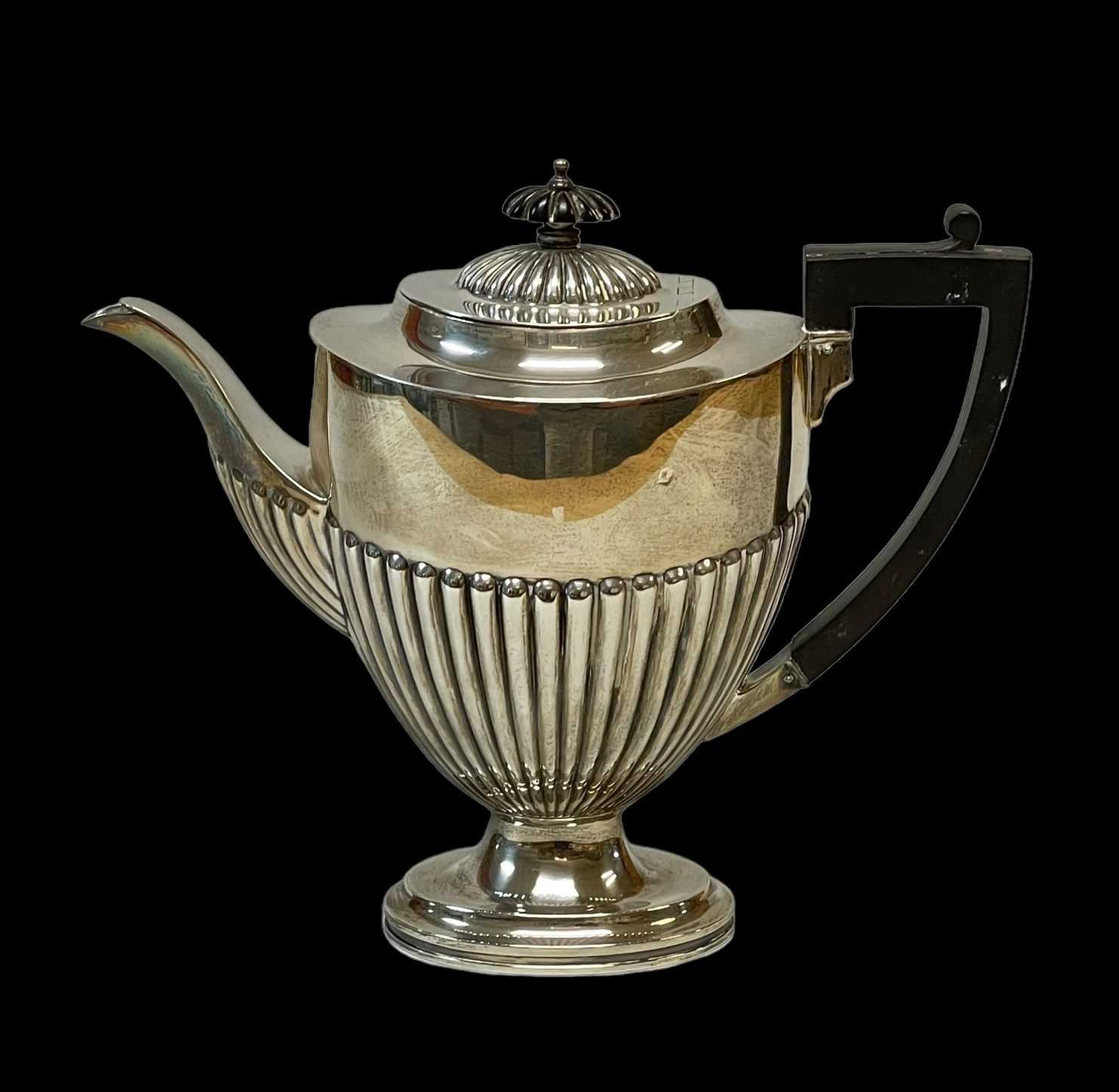 GEORGE V SILVER COFFEE POT, Chester 1920, half fluted oval form on low socle base, 24.5ozt., 23.5cms