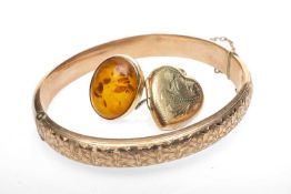 GOLD JEWELLERY comprising 9ct gold engraved hinged bangle, 9ct gold heart locket, 9ct gold amber
