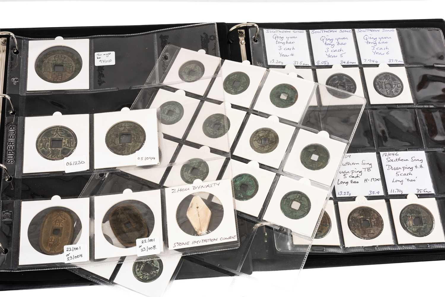 TWO COIN ALBUMS containing various collectable coins including Japanese Tenpō Tsūhō, Chinese cash