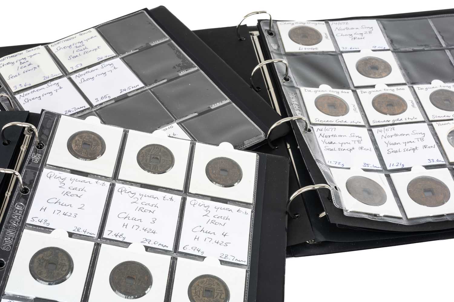 THREE COIN ALBUMS containing various believed Chinese Northern and Southern Song Dynasty iron coins,