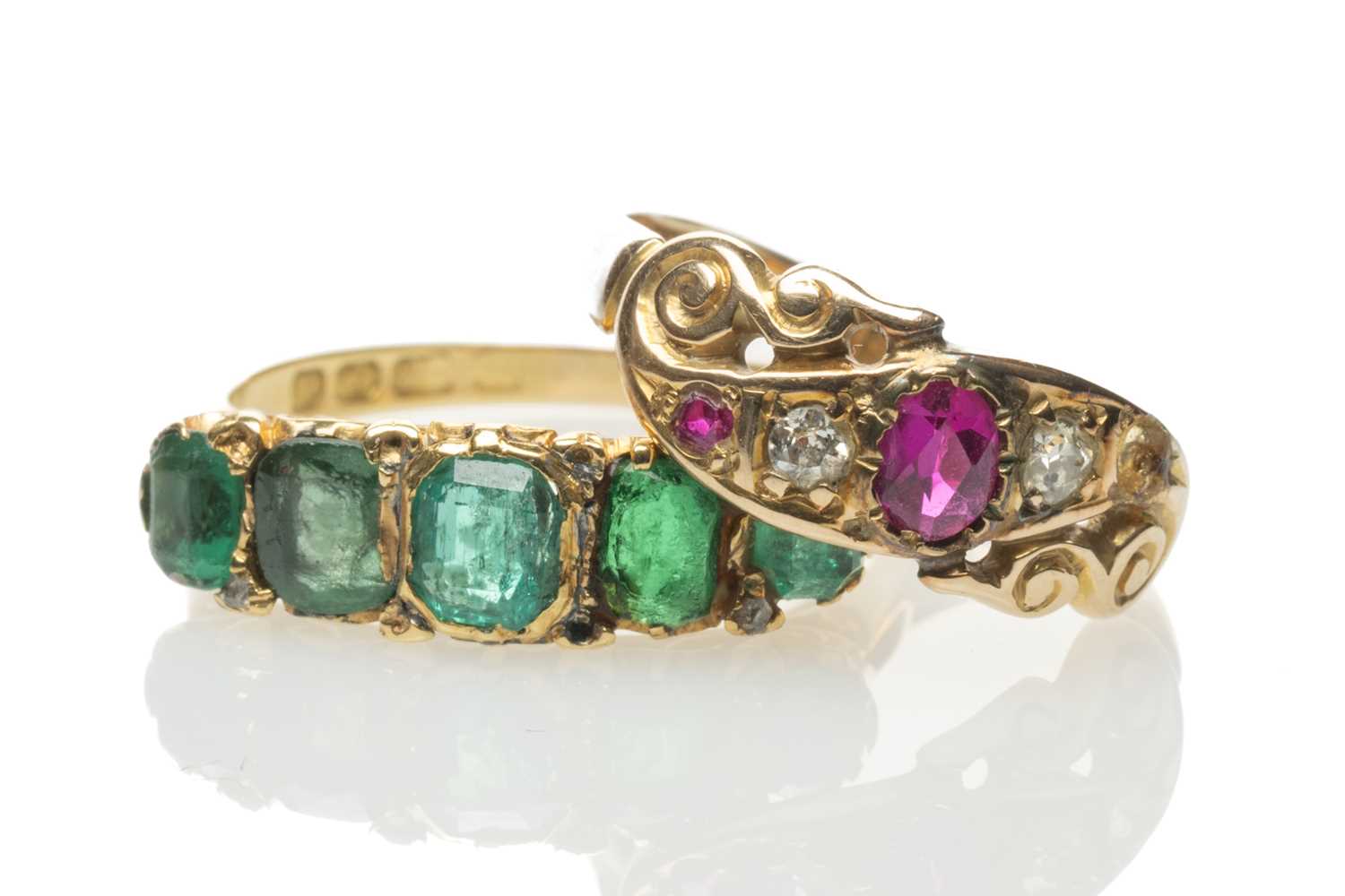 TWO GOLD RINGS comprising 18ct gold emerald and diamond chip ring, 18ct gold believed ruby and