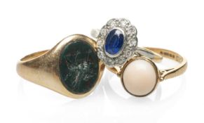 THREE GOLD RINGS comprising yellow metal bloodstone intaglio dragon ring, 9ct gold cabochon coral