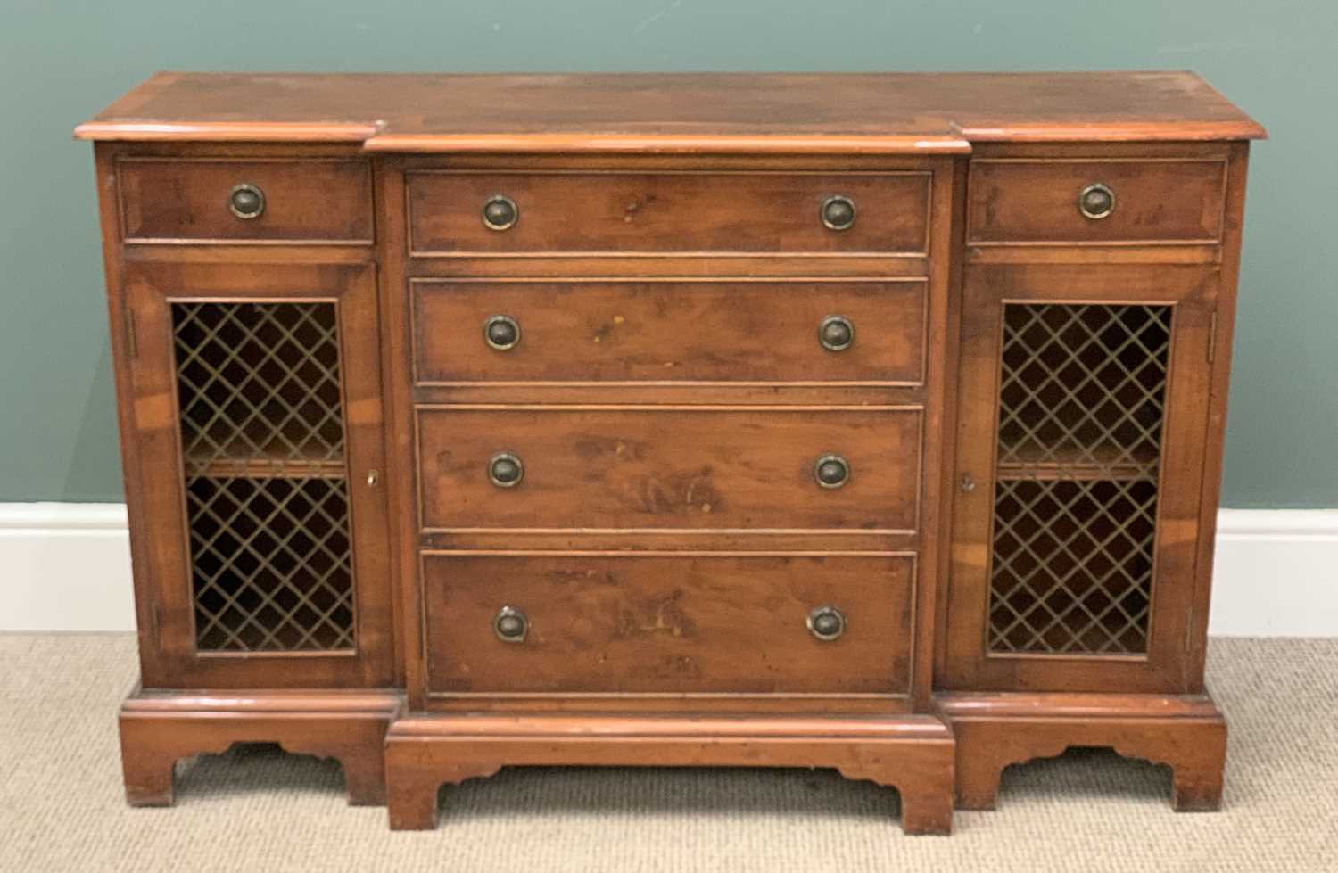 REPRODUCTION YEW EFFECT BREAKFRONT SIDEBOARD with central drawers, 76 (h) x 119 (w) x 34cms (d)