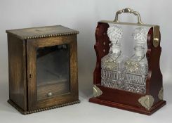 EDWARDIAN OAK SMOKER'S CABINET, the top mounted with a plated shield, glazed single door enclosing