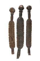 THREE TOUAREG TENT PEGS, probably Niger, all with geometric carved decoration, tallest 79cms (h) (3)