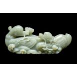CHINESE CELADON JADE CARVING OF MANDARIN DUCKS, late Qing Dynasty, swimming on a pond with stems