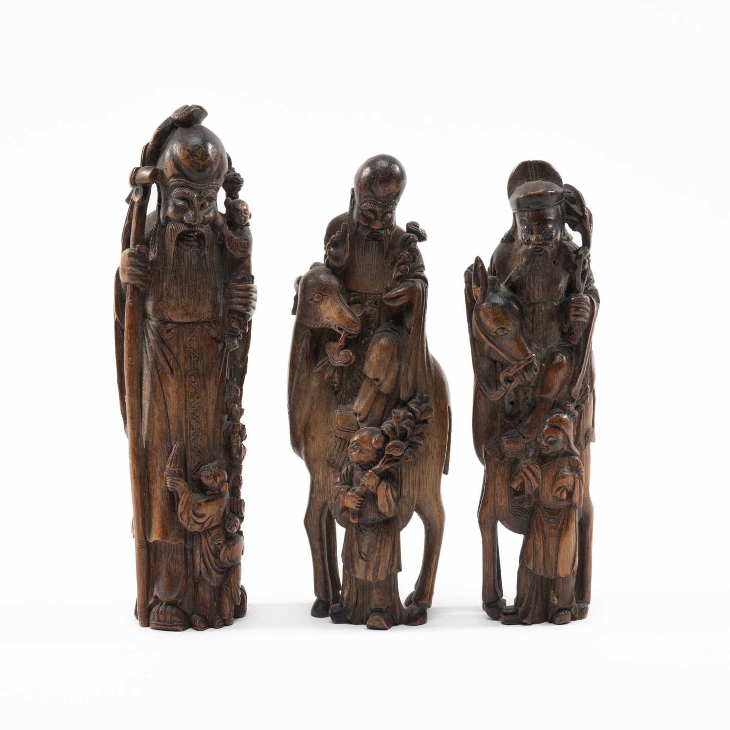 THREE CHINESE BAMBOO FIGURES OF IMMORTALS, late Qing dynasty, well carved and comprising CAO