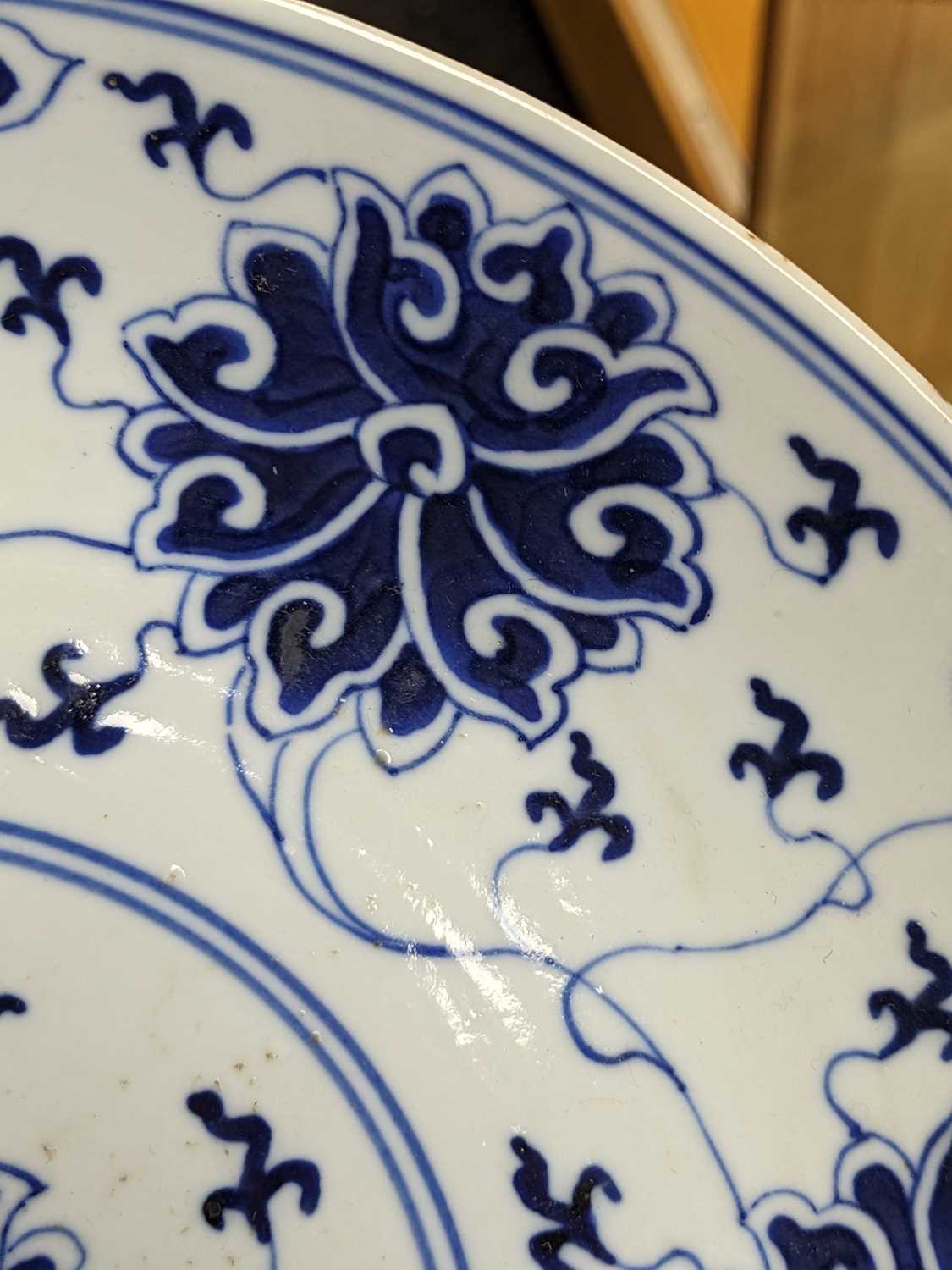 TWO SIMILAR CHINESE BLUE & WHITE 'LOTUS' SAUCER DISHES, painted in the Ming-style, one painted - Image 3 of 7
