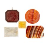 FIVE ISLAMIC CALLIGRAPHY HARDSTONE AMULETS, each with central panel surrounded by border verses, one
