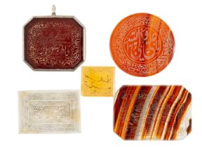FIVE ISLAMIC CALLIGRAPHY HARDSTONE AMULETS, each with central panel surrounded by border verses, one