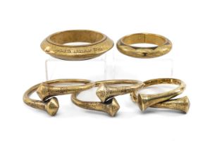 FIVE INDIAN BRASS BRACELETS, including pair of Naga bracelets from Manipur, another similar, a