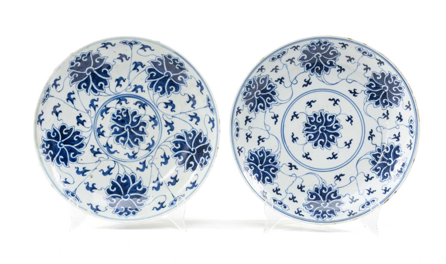 TWO SIMILAR CHINESE BLUE & WHITE 'LOTUS' SAUCER DISHES, painted in the Ming-style, one painted
