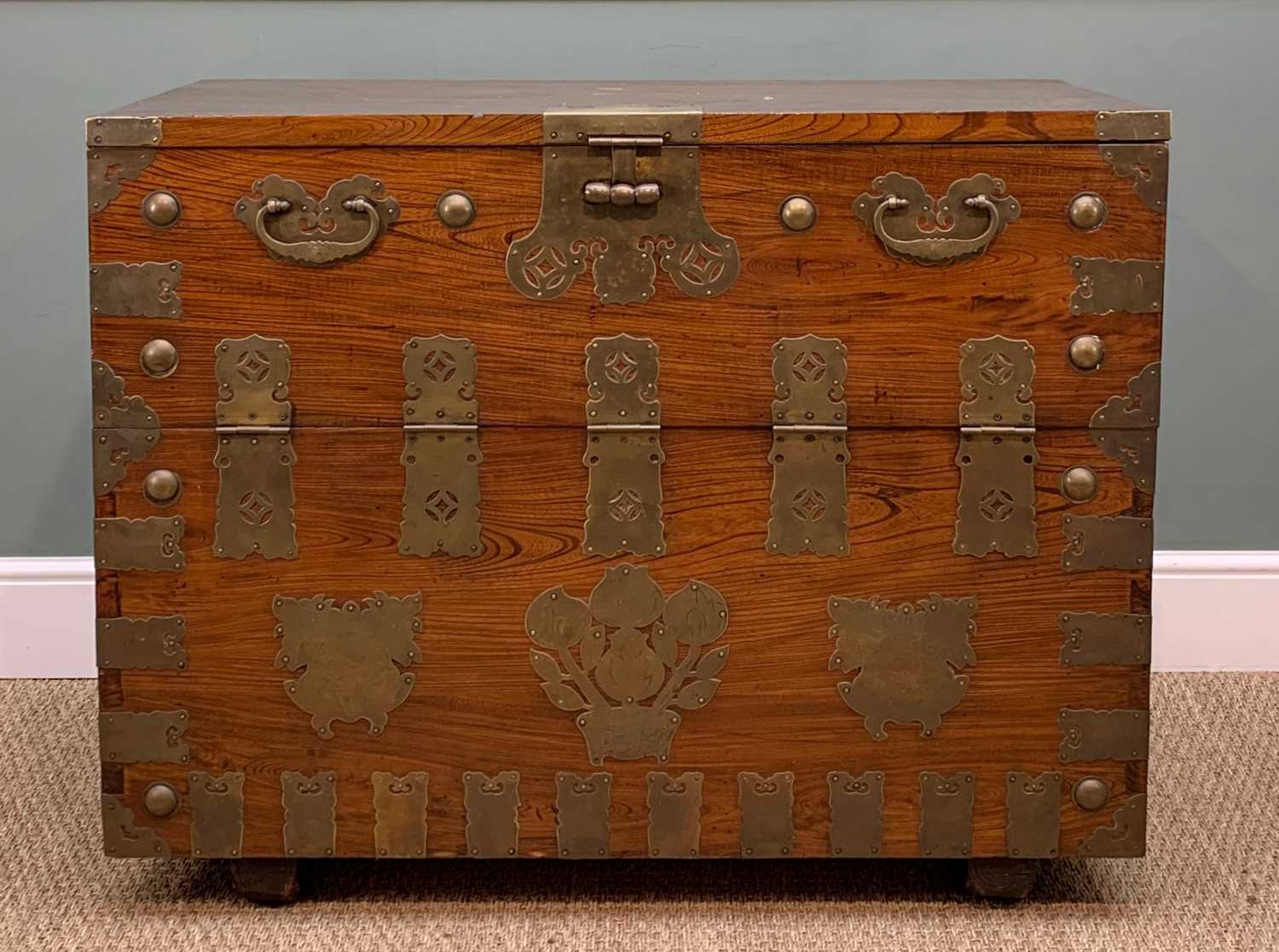 KOREAN ELM CHEST, 20th Century, with brass fittings, upper hinged panel door opeing to reveal
