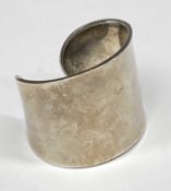 WHITE METAL CUFF BRACELET of plain design, marked 925, 55mms (w) internal, 40gms Provenance: