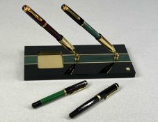 FOUR PELIKAN FOUNTAIN PENS, one maroon, one black, two green and black, with a Pelikan Perspex