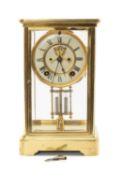 FRENCH GILT BRASS FOUR-GLASS MANTEL CLOCK, white enamel dial with Roman numerals surrounding the
