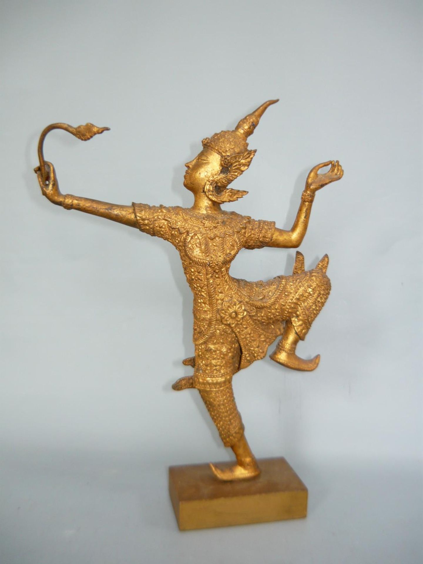Figur in ritueller Tanzpose. Bronze, vergoldet auf Holzsockel. Asien, 20.Jhdt. Gesamthöhe ca. 33cm.