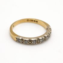 A seven stone diamond set 18 carat gold half hoop ring, the uniform brilliant cuts totalling 0.2 ...