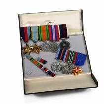 A group of WWI and later medals issued to R S Becker of the Royal Air Force, they are split into ...