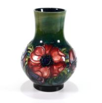 A mid 20th Century Moorcroft gourd shape vase in the Anemone pattern with tube lined flowers on a...