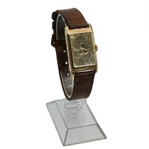 A 9 carat gold jump hour gentleman’s wrist watch, showing hours and minutes, monogrammed, the two...