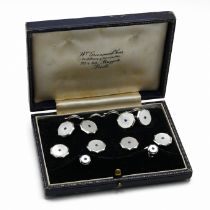 A 9 carat white gold mother of pearl and sapphire dress set, Birmingham 1953, comprising a pair o...