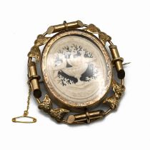 A Victorian gilt metal revolving memorial brooch, with hair arrangement to one side and Pliny’s D...