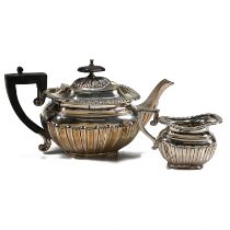 A late Victorian silver teapot and cream jug, Deakin & Deakin, Chester 1898, of rounded rectangul...